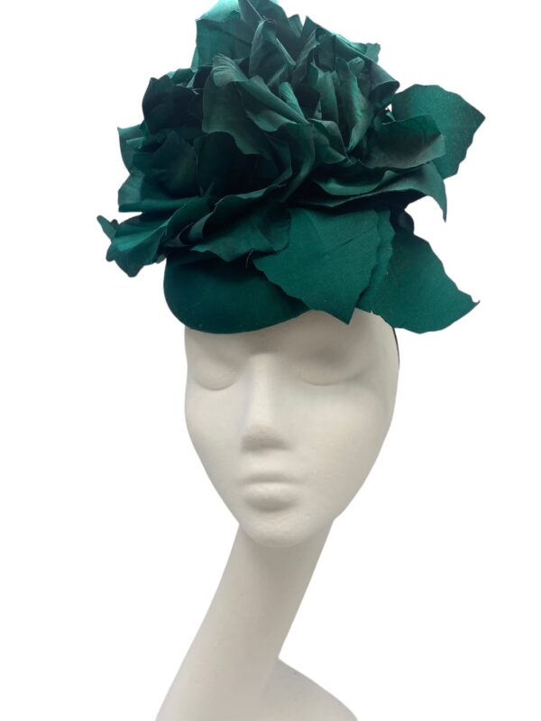 Stunning forest green headpiece with handmade silk flower detail.
