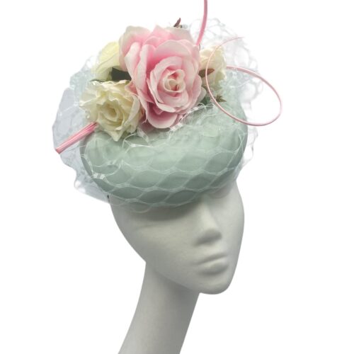 Mint green veiled headpiece with baby pink flower detail.
