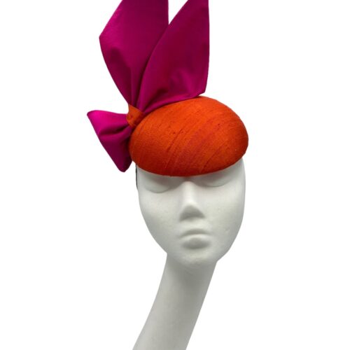 Orange raw silk headpiece with pink raw silk side bow.