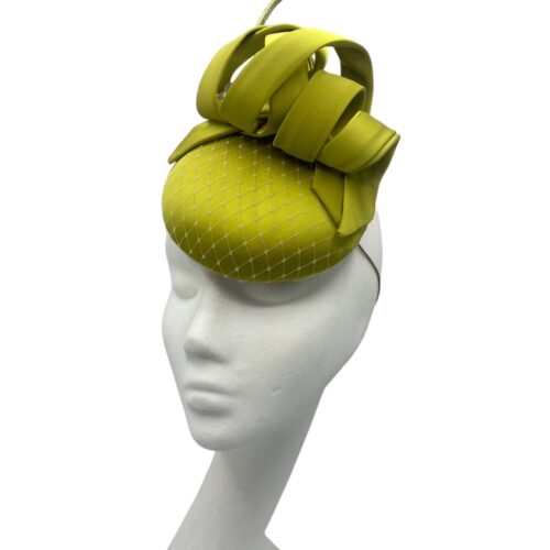 Small lime green satin headpiece with matching quill and pearl detail.