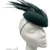 Beautiful forest green felt base headpiece with a gorgeous array of structured feather detail.