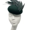 Beautiful forest green felt base headpiece with a gorgeous array of structured feather detail.