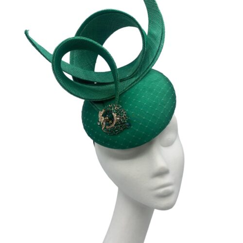 Emerald green pillbox with green swirl and jewelled detail to front.