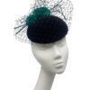 Black velvet headpiece with black veiling overlay and teal green flower detail to finish.