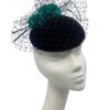 Black velvet headpiece with black veiling overlay and teal green flower detail to finish.