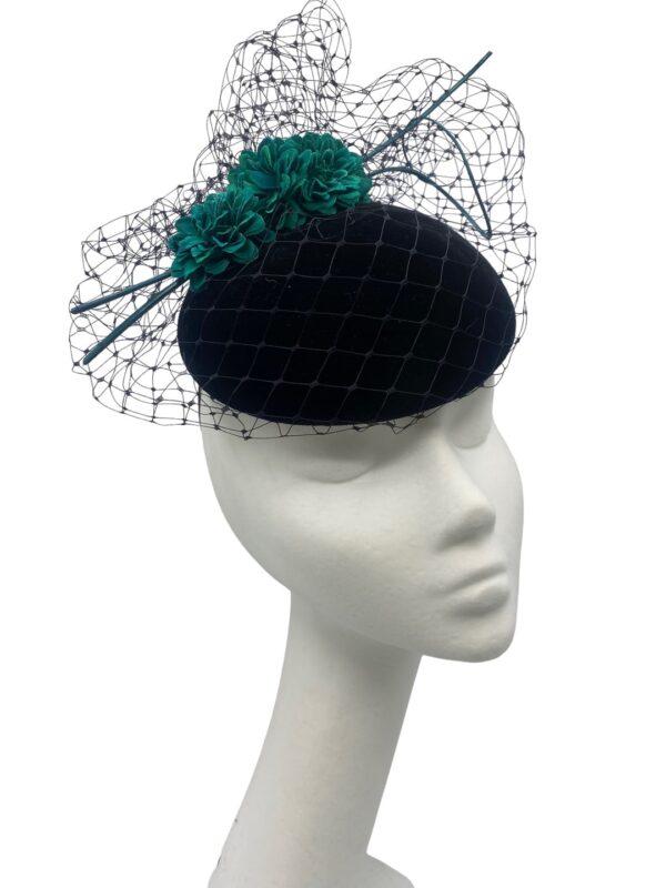 Black velvet headpiece with black veiling overlay and teal green flower detail to finish.