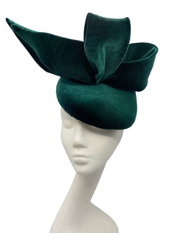 Green velvet headpiece with side bow detail on a teardrop base.