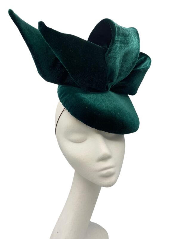 Green velvet headpiece with side bow detail on a teardrop base.