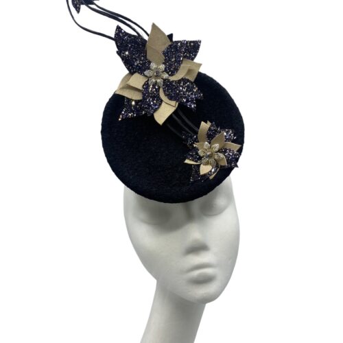 Black percher headpiece with stunning extended black quills with champagne gold and black flower detail on each quill.