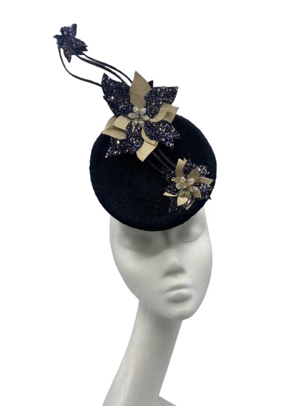 Black percher headpiece with stunning extended black quills with champagne gold and black flower detail on each quill.