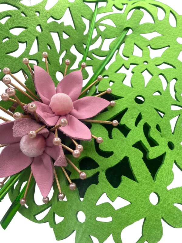 Green laser cut headpiece with forest green base and pink flower detail.