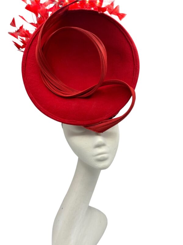Red felt front facing red percher headpiece with stunning red leopard print detail to the base which can only be seen from side and back and finished with red flowers to the back.