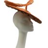 Orange saucer hat with large swirl detail with gold design detail overlay. 