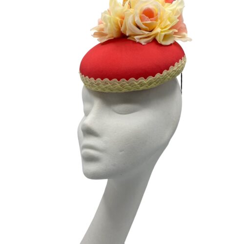 Coral coloured headpiece with lemon trim and flower detail.
