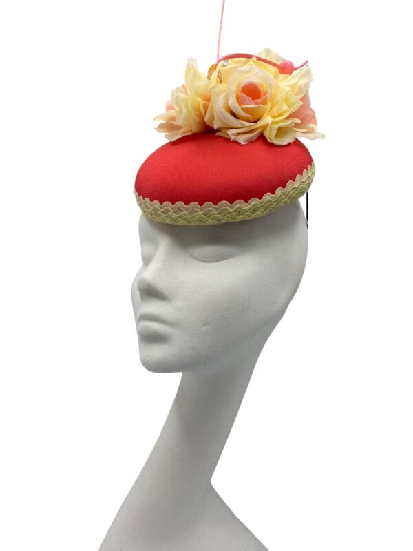 Coral coloured headpiece with lemon trim and flower detail.