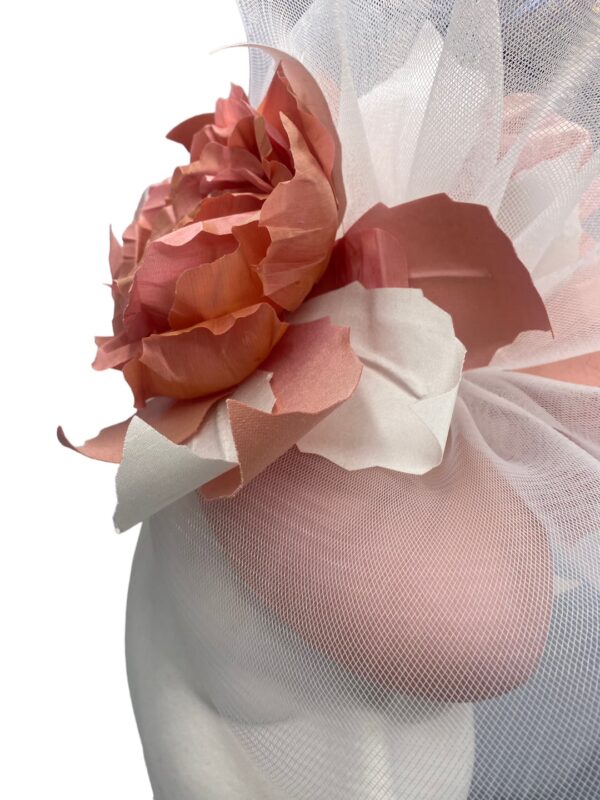 Large coral headpiece with stunning handmade flower detail covered in a stunning white crin overlay.
