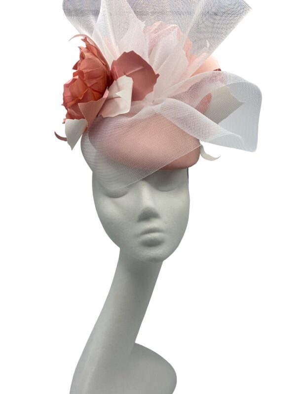 Large coral headpiece with stunning handmade flower detail covered in a stunning white crin overlay.