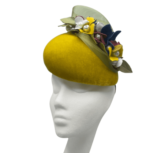 Mustard velvet teardrop shaped headpiece with multicoloured leather flowers with pearl detail to the flower centres.