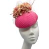 Stunning coral pink headpiece with complementary flowers and veiling to match.