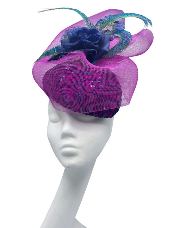 Pink teardrop headpiece with a navy lace overlay to the base,  finished with a beautiful pink overlay and an array of peacock feathers.