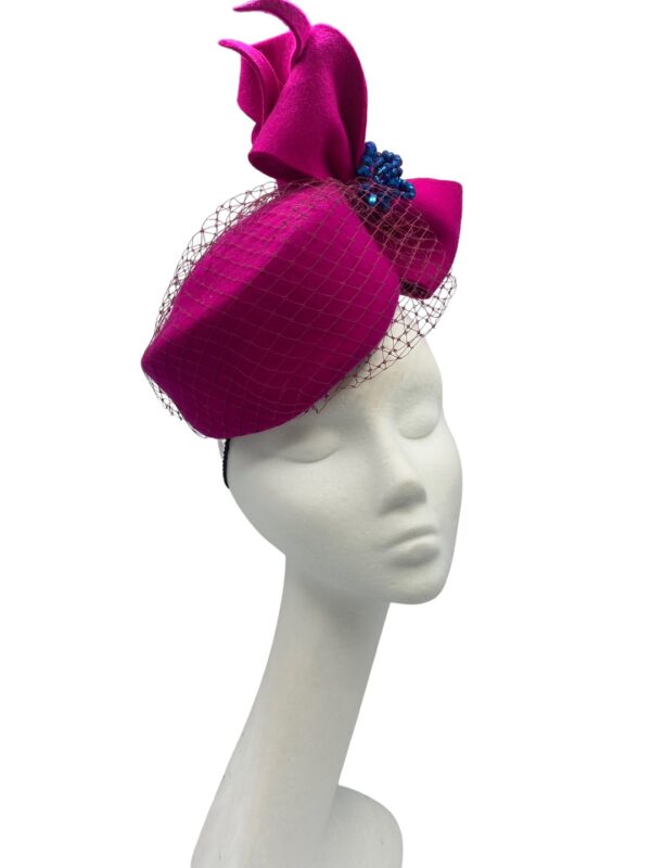 Fuschia pink felt Jackie Onassis inspired headpiece with stunning blue beaded detail.