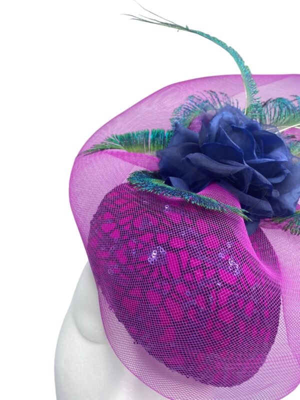 Pink teardrop headpiece with a navy lace overlay to the base,  finished with a beautiful pink overlay and an array of peacock feathers.