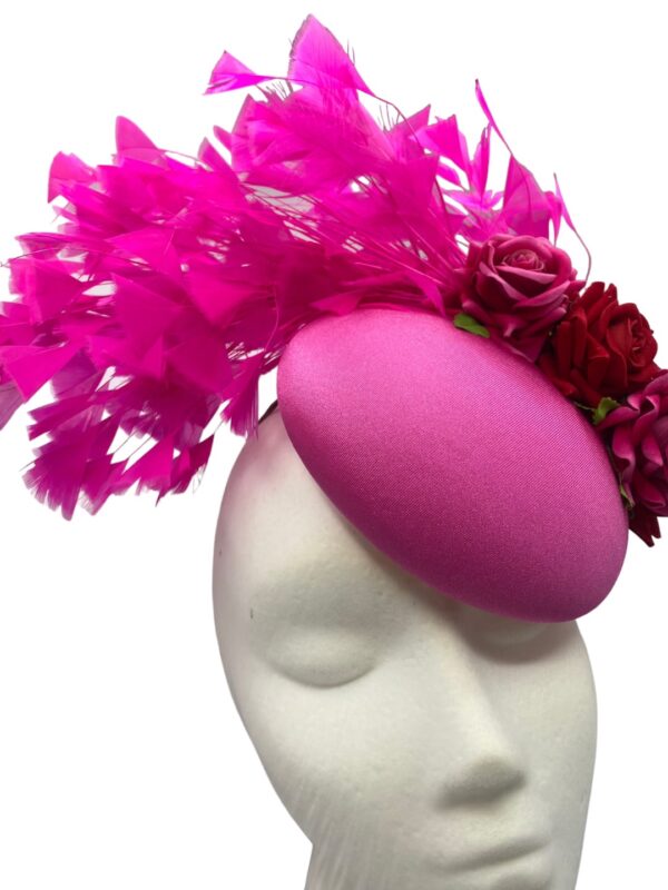 Stunning candy pink headpiece with matching pink feathers and red roses detail. 