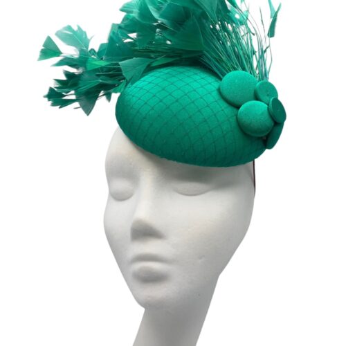 Stunning emerald green headpiece with a gorgeous spray of feathers to finish.