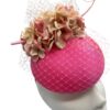 Stunning coral pink headpiece with complementary flowers and veiling to match.