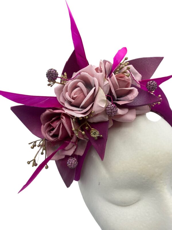 Fabulous magenta pink crown with flower and feather detail.