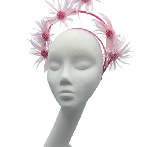 Stunning pink tiered crown with feather flower detail.