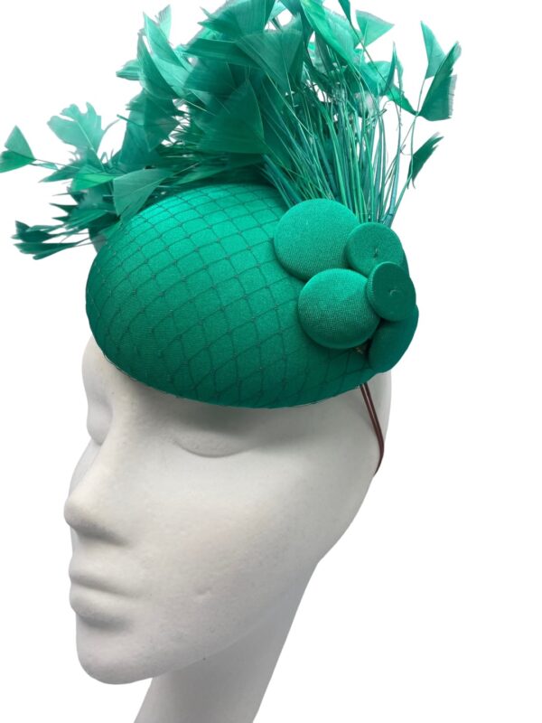 Stunning emerald green headpiece with a gorgeous spray of feathers to finish.