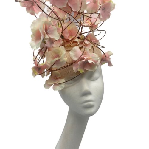 Show stopper headpiece with natural coloured base with rose gold wired detail encrusted with pink flowers.
