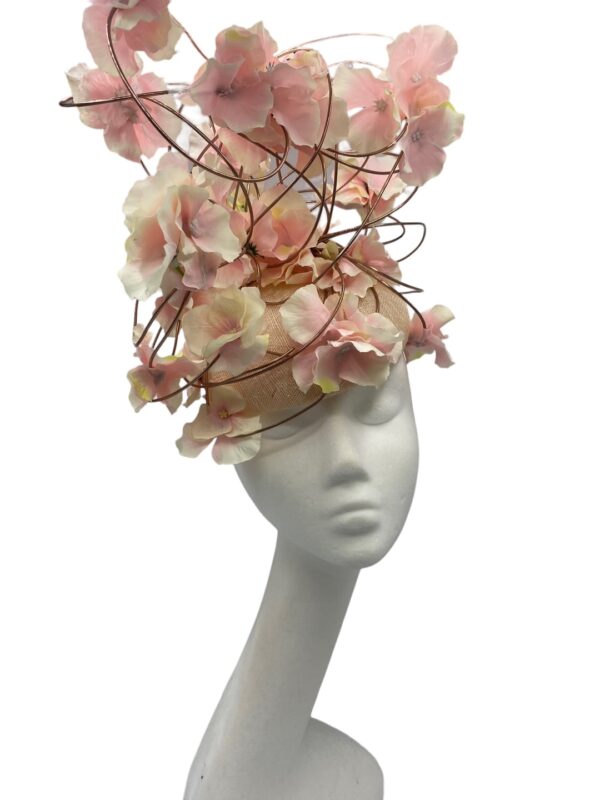 Show stopper headpiece with natural coloured base with rose gold wired detail encrusted with pink flowers.