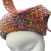Stunning pink tweed hat with matching swirl detail. This headpiece has some colour through the tweed fabric.
