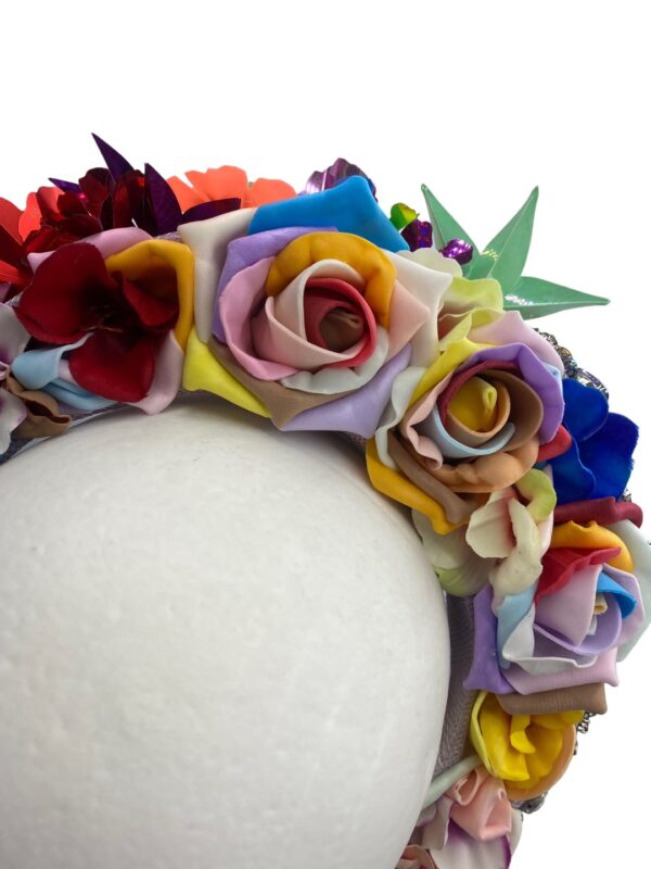 Stunning multicoloured foil headpiece on front with an array of multicoloured foam handmade flowers to the back.