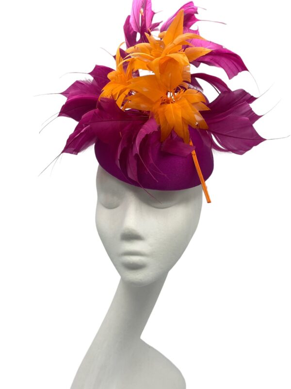 Stunning magenta pink headpiece with matching magenta and orange feather structure detail.