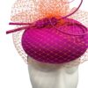 Gorgeous magenta pink headpiece with stunning orange veiling overlay with orange quill to finish.