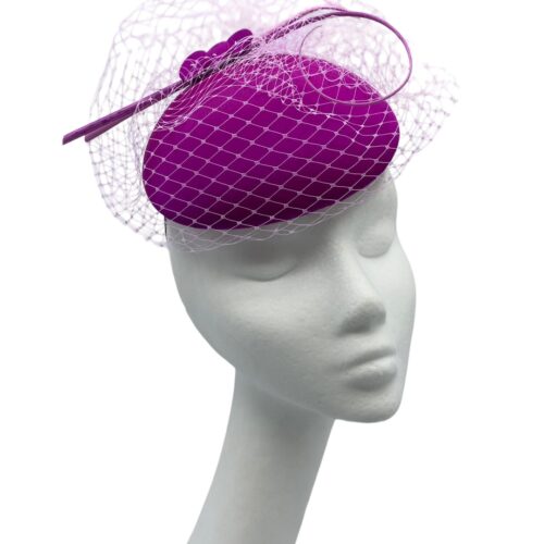 Stunning magenta pink headpiece with baby pink veiling and quill detail.