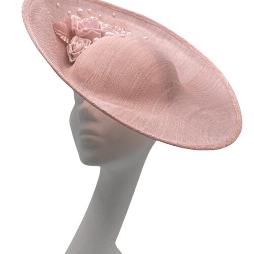 Large side saucer pink/peach tone headpiece with stunning flower detail, headpiece is on a headband.