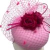 Stunning baby pink headpiece with fuchsia pink veiling and flower contrast detail.
