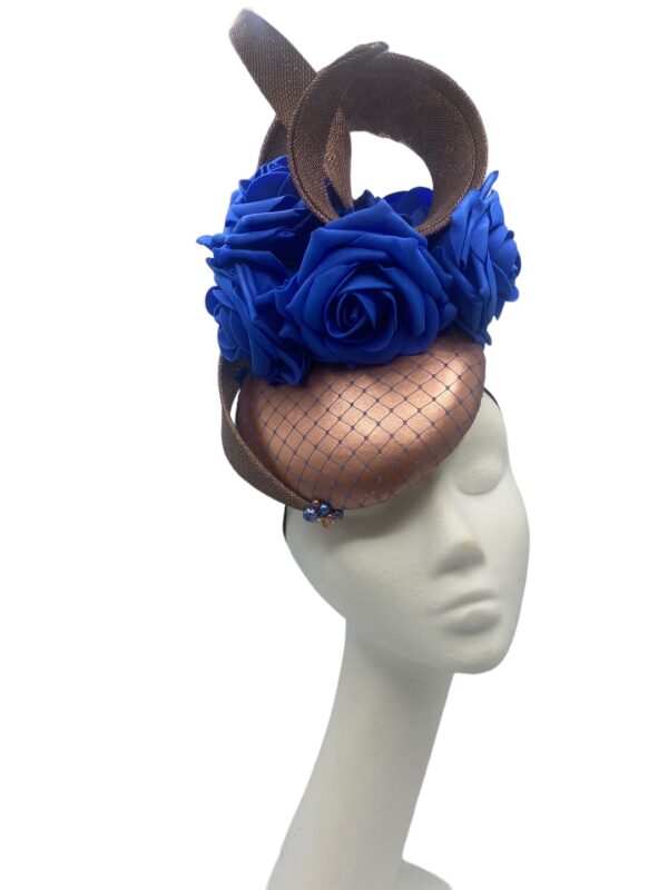 Rose gold headpiece with blue flowers finished with a blue netting overlay to the base.