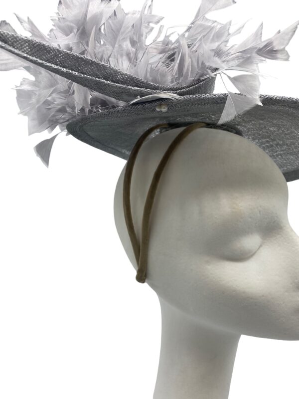 Stunning silver/grey side saucer headpiece on a headband, complete with a stunning array of feathers.