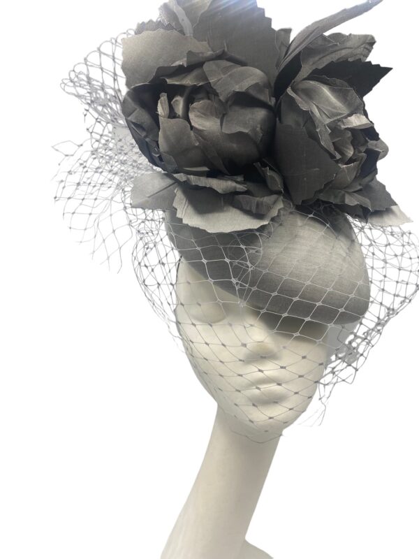 Large silver/grey headpiece with flower and veiling detail to finish.