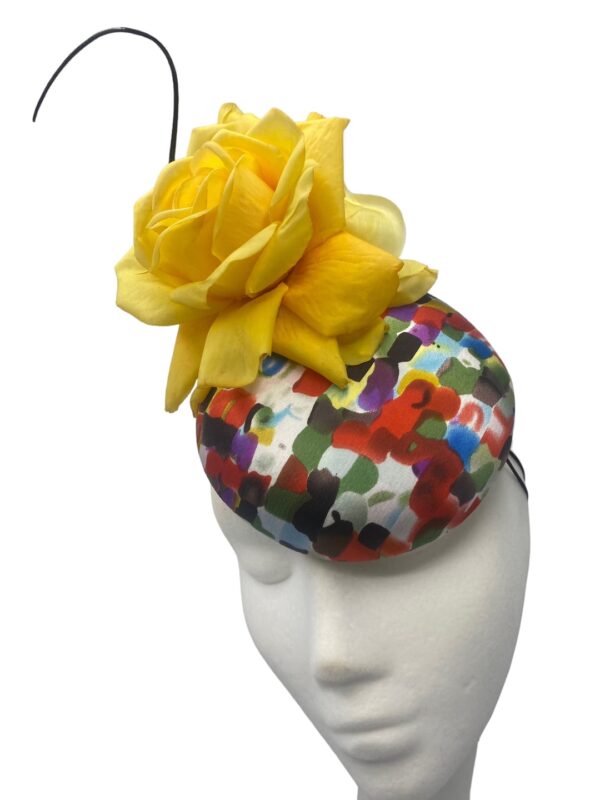 Multi-coloured headpiece with yellow flower.