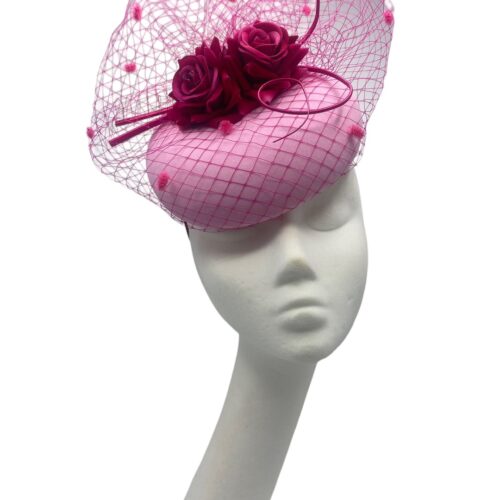Stunning baby pink headpiece with fuchsia pink veiling and flower contrast detail.