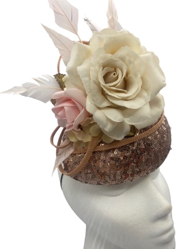 Rose gold sequinned headpiece with pastel colour flower and feather detail to finish.