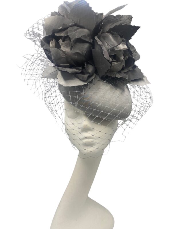 Large silver/grey headpiece with flower and veiling detail to finish.