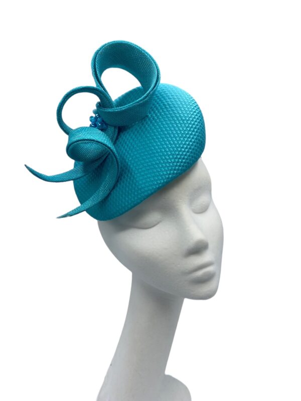 Stunning teal/turquoise headpiece with beaded structured detail.