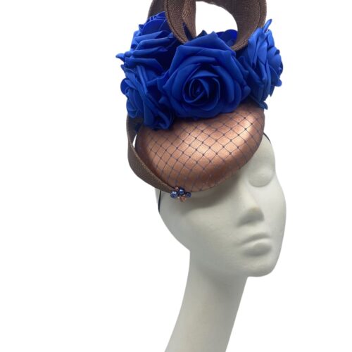 Rose gold headpiece with blue flowers finished with a blue netting overlay to the base.